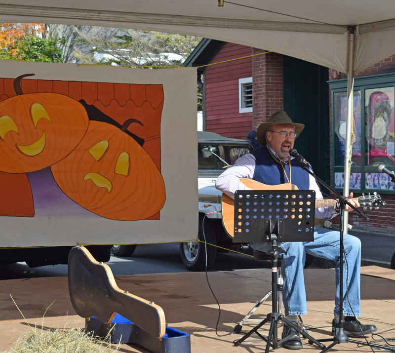 Bruce Hardina plays on a stage set up outside the Lincoln Theater as part of the 13th annual Damariscotta Pumpkinfest & Regatta festivities Sunday, Oct. 13. (Evan Houk photo)