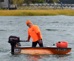 Buzz Pinkham, co-founder of Pumpkinfest, coasts to the dock in Damariscotta Harbor after handily winning the motorized race during the 13th annual Damariscotta Pumpkinfest Regatta on Monday, Oct. 14. (Evan Houk photo)