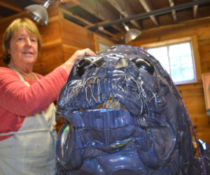 Artist Marnie Sinclair works on her seal sculpture titled "Seamore Plastic" at River Arts in Damariscotta on Wednesday, Oct. 9. (Christine LaPado-Breglia photo)