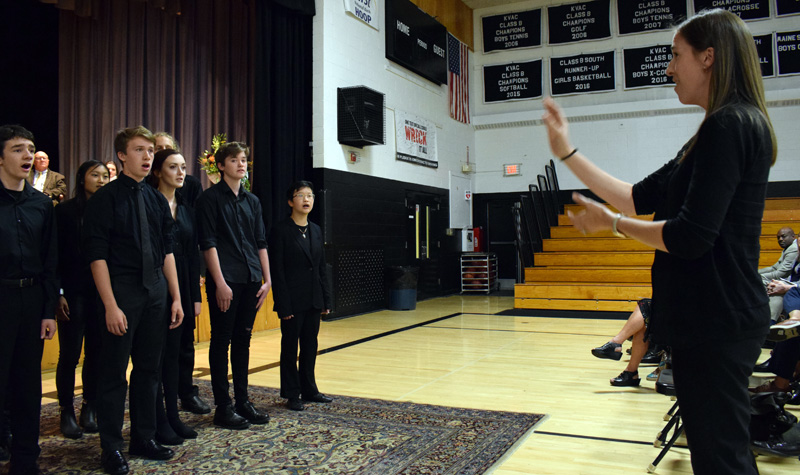 Emily Anderson directs the Lincoln Academy Lincolnaires in a rendition of a South African freedom song, "Siyahamba," during the installation ceremony for new Head of School Jeffrey S. Burroughs on Saturday, Oct. 5. (Evan Houk photo)