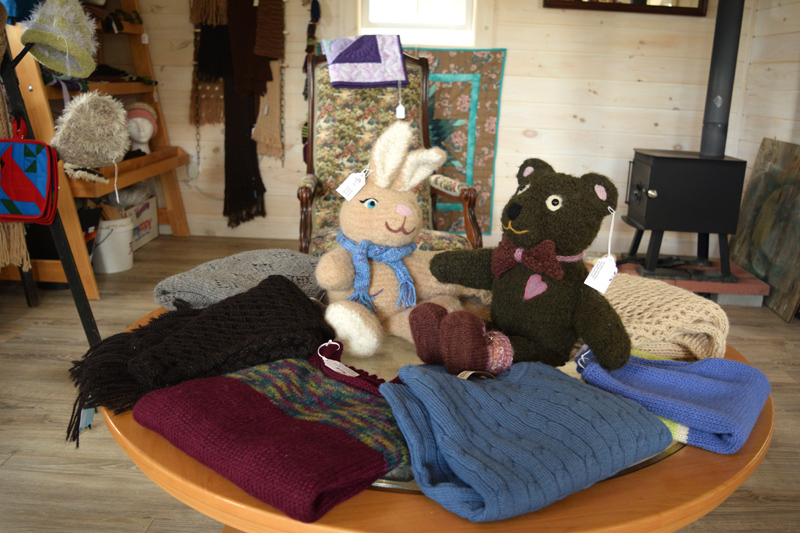 Stuffed animals made out of alpaca fiber, surrounded by other handmade items. (Jessica Clifford photo)