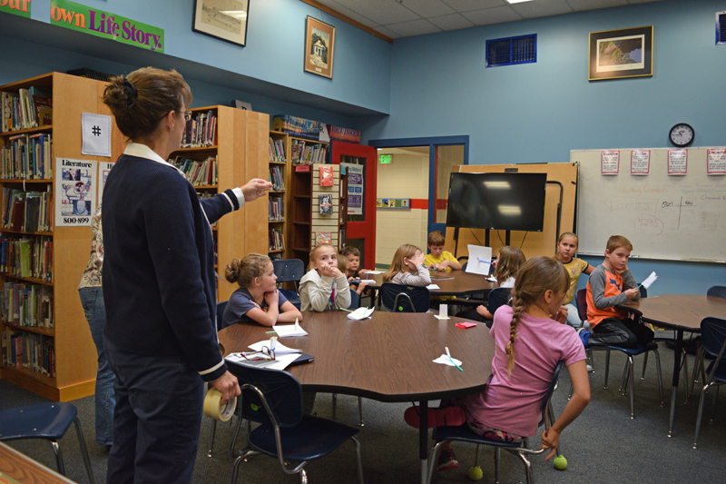 Clarissa Howard, learning commons guide at Whitefield Elementary School, asks students questions after they made rockets from paper, tape, and a straw on Friday, Oct. 4. (Jessica Clifford photo)