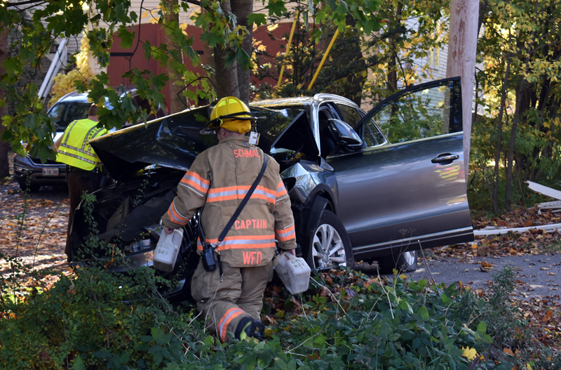 A Wiscasset firefighter works at the scene of a single-vehicle crash on Route 1 in Wiscasset the afternoon of Saturday, Oct. 26. (Alexander Violo photo)