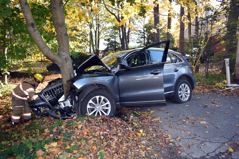 A firefighter inspects an Audi SUV after a crash near Wiscasset village the afternoon of Saturday, Oct. 26. (Alexander Violo photo)