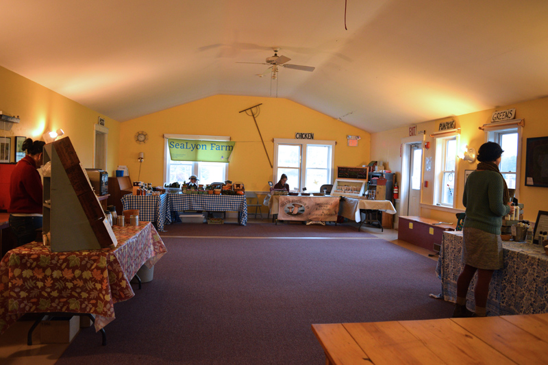 Wiscasset Winter Farmers Market vendors keep warm inside the educational room at The Morris Farm. (Jessica Clifford photo)