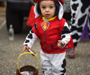 Camden Gordon, 1, collects candy in his Paw Patrol costume at Damariscotta's trunk-or-treat Wednesday, Oct. 31, 2018. (LCN file photo)