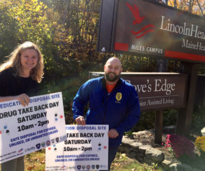 Damariscotta Chief of Police Jason Warlick and Healthy Lincoln County Project Coordinator Jess Breithaupt put out signs for the semiannual Drug Take Back Day.