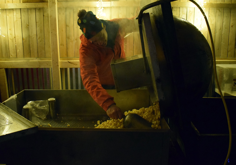 Lester Spear, organizer of the Food Trucks A-Go food truck court on Route 27 in Boothbay, dumps out a fresh batch of kettle corn at his mobile stand, Cameron Clan Snack Co., Saturday, Nov. 23. (Evan Houk photo)