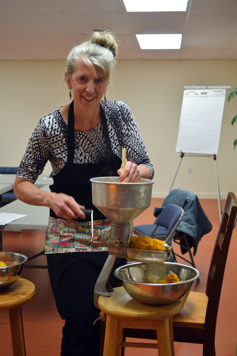 Sally Ingraham, coordinator of the Lincoln County Gleaners and project assistant at Healthy Lincoln County, participates in a "pumpkin-processing palooza" Thursday, Nov. 21. (Jessica Clifford photo)