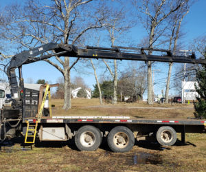 N.C. Hunt Lumber assists with the placement of a tall Christmas tree at Coastal Rivers Conservation Trust in Damariscotta for the Villages of Light celebration.