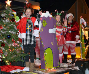 Members of the Waltz family wave from their Grinch-themed float during the Parade of Lights on Nov. 24, 2018. (Maia Zewert photo)