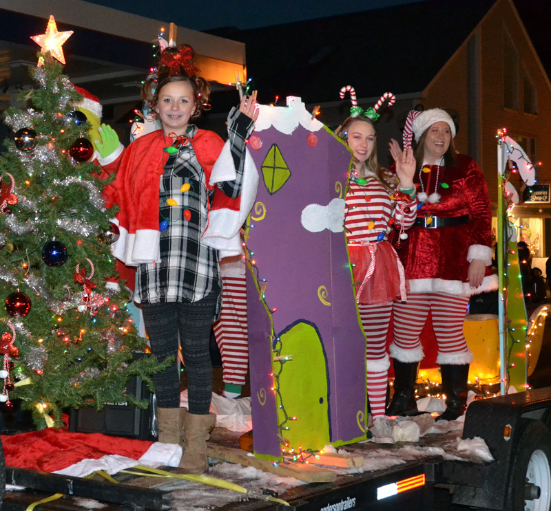 Members of the Waltz family wave from their Grinch-themed float during the Parade of Lights on Nov. 24, 2018. (Maia Zewert photo)