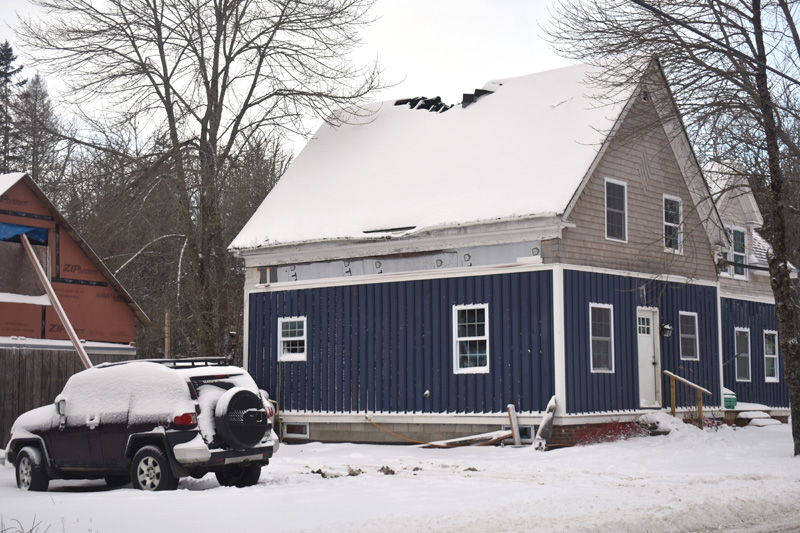 Fire damage is visible at the peak of the roof of 211 Medomak Road in Bremen. A chimney fire spread to the roof Monday, Dec. 2, according to Bremen Fire Chief Donnie Leeman. (Alexander Violo photo)