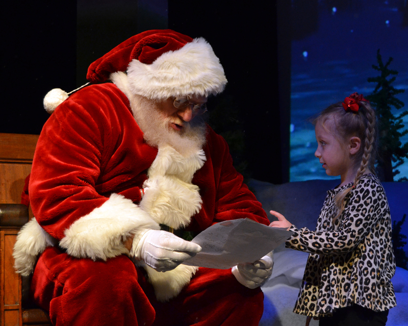 Santa reads a letter from Cali Noriega, 4, of Bristol, during a Villages of Light event at the Lincoln Theater in Damariscotta on Saturday, Nov. 30. (Maia Zewert photo)