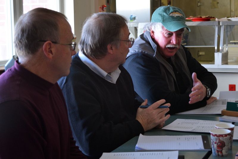 From left: Chuck Race and Edgecomb Selectman Ted Hugger listen to Jack Brennan speak about the town's snowplowing contract and the potential for a municipal public works department. (Jessica Clifford photo)