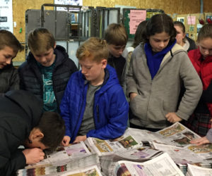 Great Salt Bay Community School eighth graders inspect the print quality of the forthcoming edition of The Lincoln County News during a visit to Lincoln County Publishing Co. in Newcastle on Wednesday, Dec. 11.