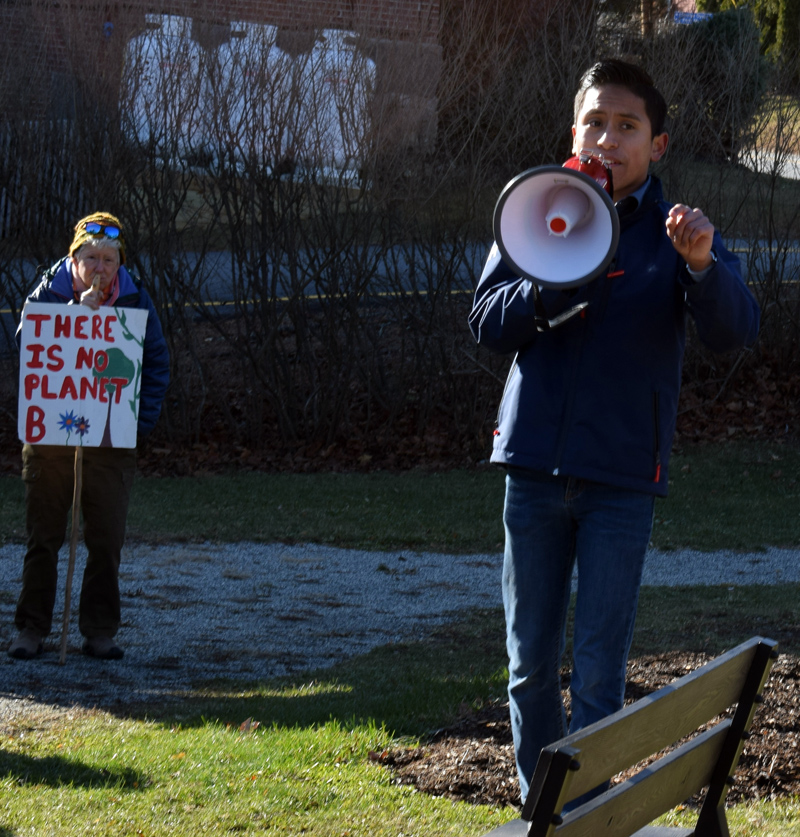 Cameron Nelson, of the Lincoln Academy Climate Action Club, addresses nearly 90 people with a megaphone during the club's rally at Veterans Memorial Park in Newcastle on Friday, Nov. 29. (Evan Houk photo)