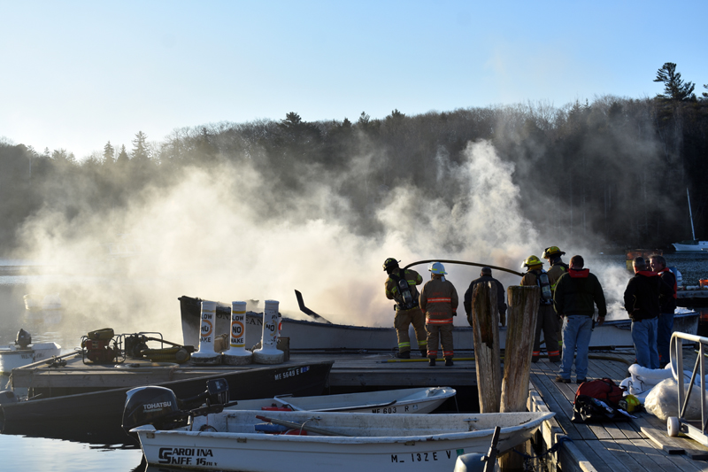 Firefighters extinguish a boat fire in South Bristol on Christmas Eve. (Alexander Violo photo)