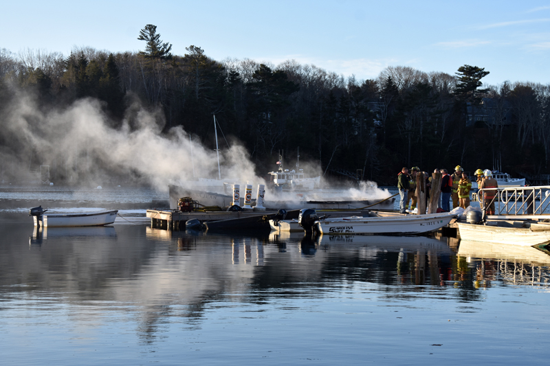 Smoke and steam rises from the hull of a lobster boat in South Bristol on Christmas Eve. (Alexander Violo photo)