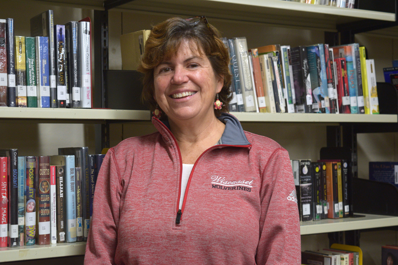 Cynthia Carter, librarian for the Wiscasset School Department, stands in the stacks at the Wiscasset Middle High School library. Carter retired Friday, Dec. 20 after 32 years in Wiscasset schools. (Jessica Clifford photo)
