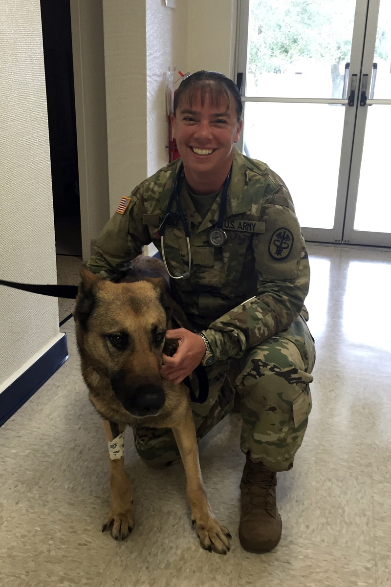 Dr. Holly Noble poses for a photo with a patient at Marine Corps Air Station Cherry Point in North Carolina. Noble, then a captain in the U.S. Army Veterinary Corps, was officer in charge of a veterinary facility on the base for three years. (Photo courtesy Holly Noble)