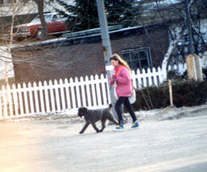 The author at about age 13 walking with her neighbor's dog to deliver newspapers. (Photo courtesy Sarah Caton)