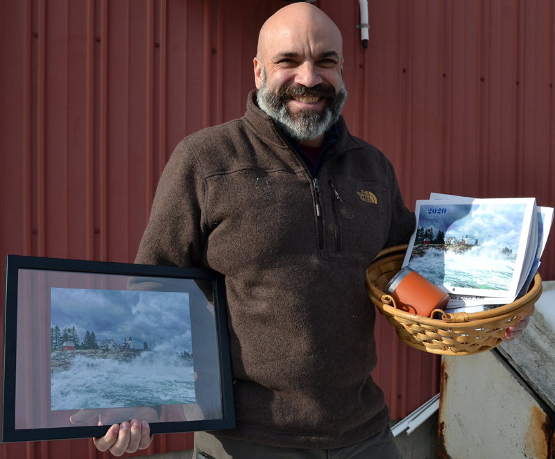 William Â“BillyÂ” Smith accepts the 2019 #LCNme365 grand prize during a visit to The Lincoln County News. As the winner of the annual contest, Smith received a prize package of products featuring his photo, including decks of playing cards, postcards, notecards, a framed print, and a 2020 calendar featuring all the monthly winners of the photo contest.