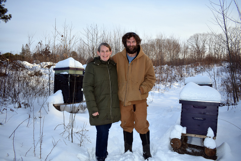 Maisie and Matthew Sturtevant, of Switchback Farm, near their beehives. The farm harvested 500 pounds of honey last year and plans to double its output in 2020, according to Matthew Sturtevant. (Alexander Violo photo)