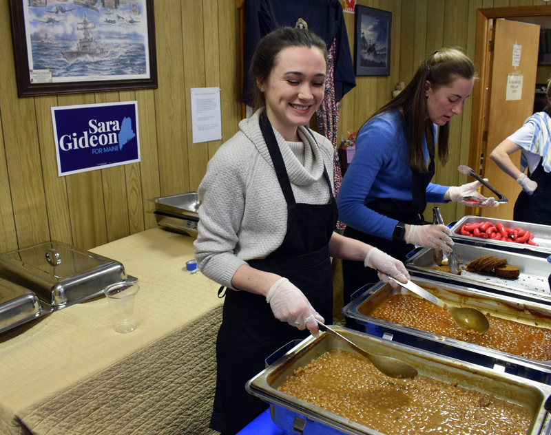 Workers with Sara Gideon's campaign for U.S. Senate serve baked beans and hot dogs at the Wells-Hussey American Legion Post in Damariscotta on Monday, Feb. 10. (Evan Houk photo)