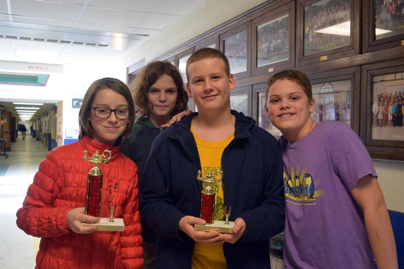 From left: Great Salt Bay Community School seventh graders Eli Melanson, Gavin Parson, Joseph Levesque, and Jayden Brown display their trophies from competition in the Central Maine Math League this year. (Jessica Clifford photo)