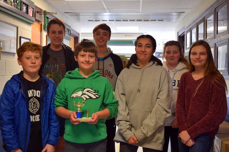 Members of Great Salt Bay Community School's eighth grade math teams display a trophy from a recent meet. Front from left: Mica Houghton, Jacob Caron, Halena Stone, and Kayla Cruz. Back from left: Connor Parson, Conor Cass, and Elizabeth Rethman. (Jessica Clifford photo)