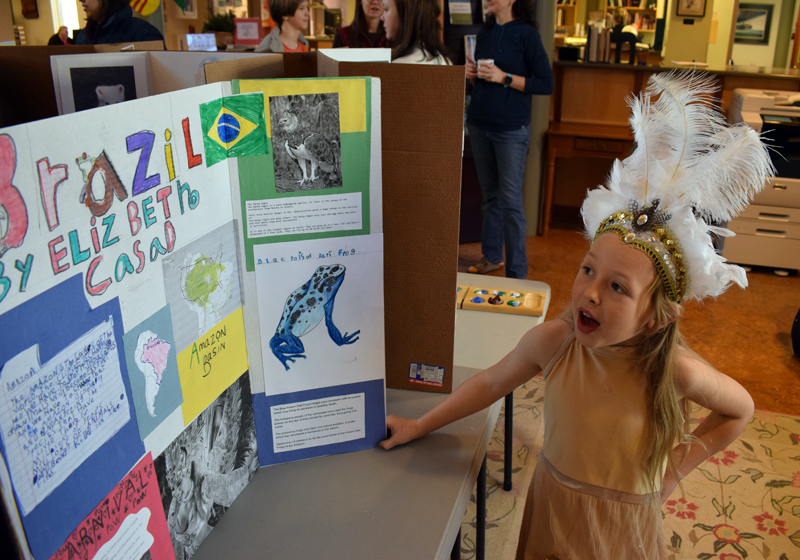 Elizabeth Casad, 8, of Bristol, answers a question about her project on Brazil during Homeschooler Cultural Day at Skidompha Library in Damariscotta on Thursday, Jan. 30. Fourteen homeschooled children from across Lincoln County participated in the event. (Evan Houk photo)