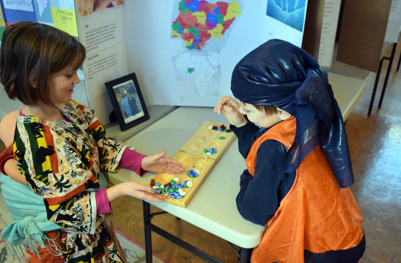 Seven-year-old homeschoolers Agnes Eddyblouin and Oliver Goding play the traditional Nigerian board game ayo during Homeschooler Cultural Day at Skidompha Library in Damariscotta on Thursday, Jan. 30. (Evan Houk photo)