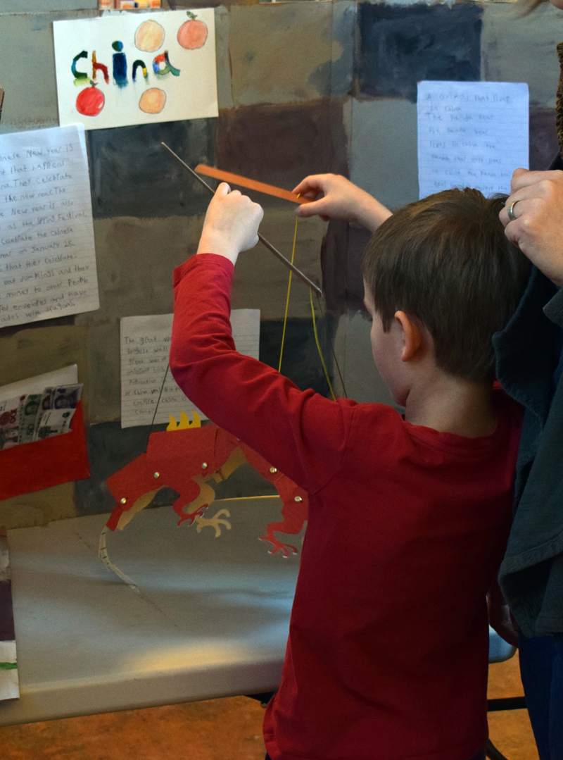 A young boy plays with a prop at the China display during Homeschooler Cultural Day at Skidompha Library in Damariscotta on Thursday, Jan. 30. (Evan Houk photo)