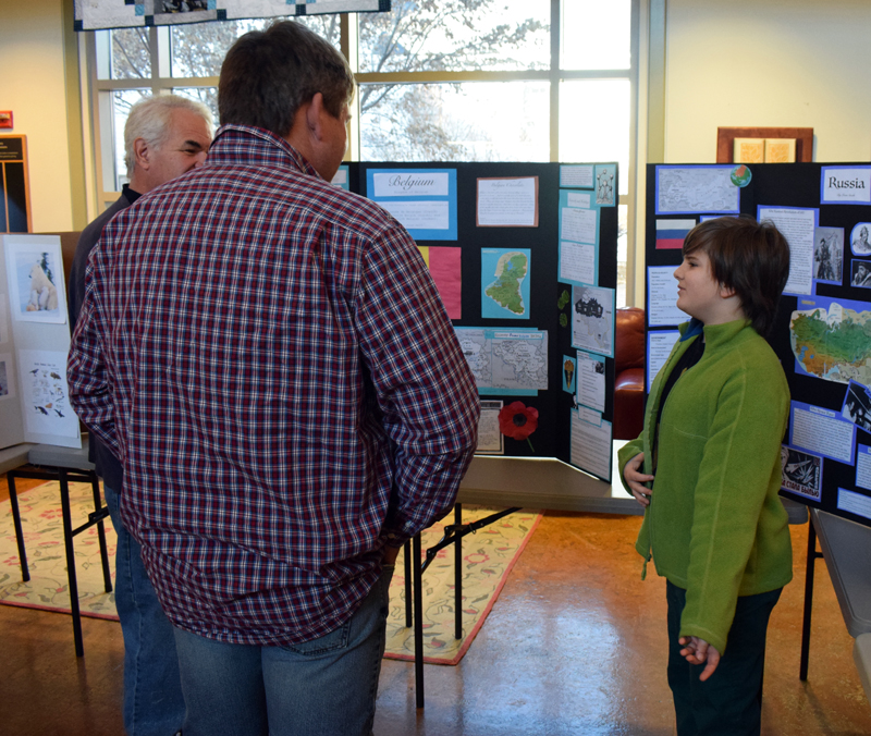 Jonah Smith, 11, explains his project on Belgium to visitors during Homeschooler Cultural Day at Skidompha Library in Damariscotta on Thursday, Jan. 30. (Evan Houk photo)