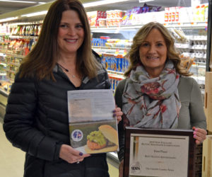 From left: Julie Greenleaf, advertising representative for The Lincoln County News, holds an award-winning advertisement for Main Street Grocery while Main Street Grocery owner Jane Gravel holds the award. The LCN won first place for native advertising in the New England Newspaper and Press Association Better Newspaper Contest. The winning advertisement was a featured recipe page in Lincoln County Magazine.