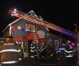 Firefighters work to ventilate One of Those Days Antiques and Collectibles, after a structure fire, Wednesday, Feb. 26. (Alexander Violo photo)