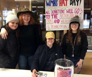 From left: Madison Westrich, Jazzy Bush, Cara Viele, and Kayla Delano staff a donation table in the lobby of Wiscasset Middle High School on hat day, Jan. 24, to raise money for victims of the Australian wildfires. (Photo courtesy Deb Pooler)