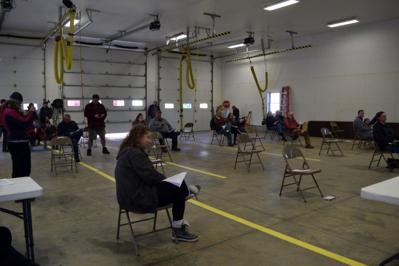 Alna voters practice social distancing during annual town meeting in the truck bay of the fire station Saturday, March 21. Thirty-two people attended. (Jessica Clifford photo)