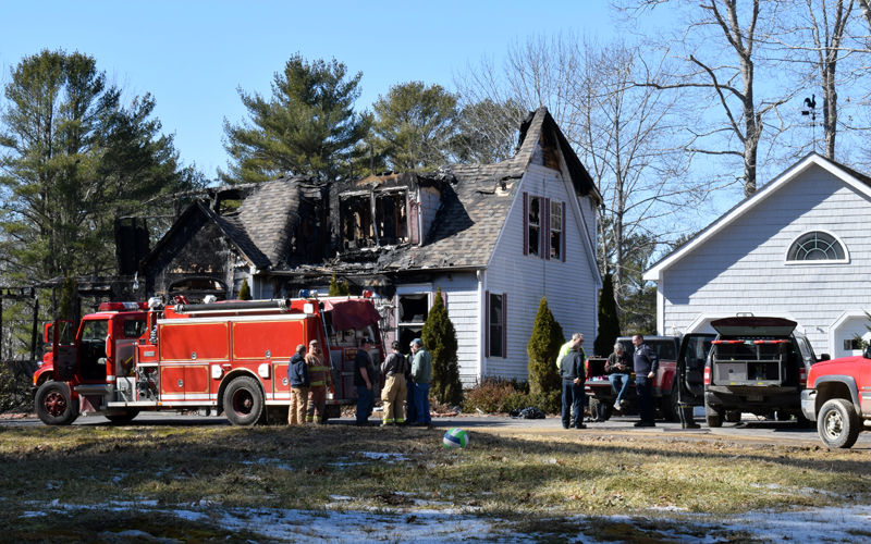 Boothbay firefighters monitor the remains of a house at 30 Sunny Acres Lane after a fire early Thursday, March 5. The fire started shortly after midnight, then rekindled around 6 a.m. (Evan Houk photo)