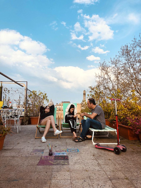 From left: Damariscotta native and opera singer Kate Aldrich relaxes with her 9-year-old daughter, Livy, and husband, Riccardo Minasi, on the roof of the couple's home, which overlooks a piazza in Rome. Aldrich and her family have been living under lockdown in Italy since March 10. (Photo courtesy Kate Aldrich)