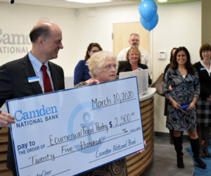 Greg Dufour, president and CEO of Camden National Bank, presents a $2,500 check to Jennifer Ober, president of the Ecumenical Food Pantry, during the grand opening of the bank's new branch in Damariscotta. (Evan Houk photo)