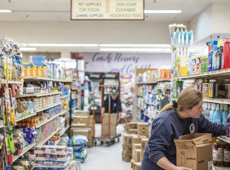 Emily Pierce stocks cleaning supplies at Main Street Grocery in Damariscotta on March 28. IGA recently named Main Street Grocery one of its Five-Star Retailers for 2020. (Bisi Cameron Yee photo, LCN file)