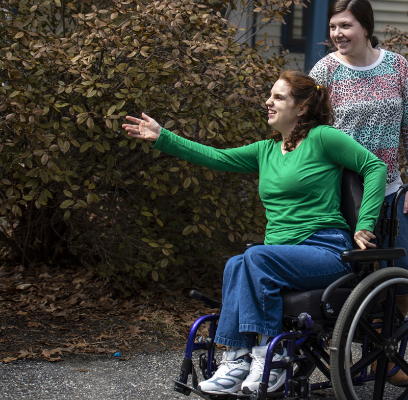 Vicki L'Heureux (left) reaches out for a hug at a Mobius Inc. residence in Newcastle on March 31. Physical distancing is an emotionally difficult issue for both residents and staff. (Bisi Cameron Yee photo)