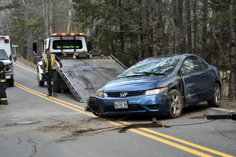 A Honda Civic coupe is removed from Bunker Hill Road in Jefferson after a rollover Tuesday, April 7. The driver suffered unknown injuries, while a passenger was unhurt, according to police. (Alexander Violo photo)