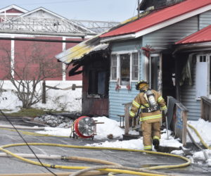 A firefighter works outside Captainâ€™s Fresh Idea, on Route 1 in Waldoboro, the afternoon of Easter Sunday, April 12. Fire caused heavy damage to the interior of the building, according to Waldoboro Deputy Fire Chief Dale Smith. (Alexander Violo photo)