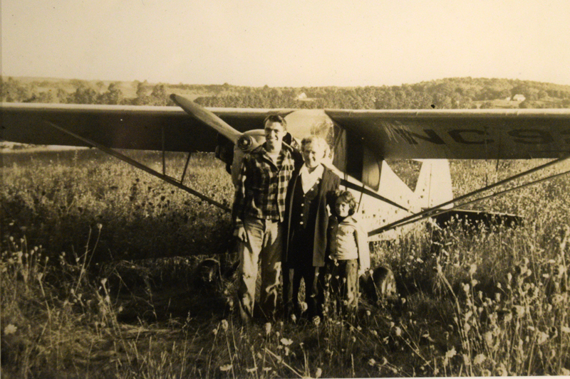 Billy Post, the pilot; Verlie Greenleaf; and Verlie Greenleaf's granddaughter, Asenath "Senie" Greenleaf, pose for a photo after the first plane landing on Westport Island in 1948.