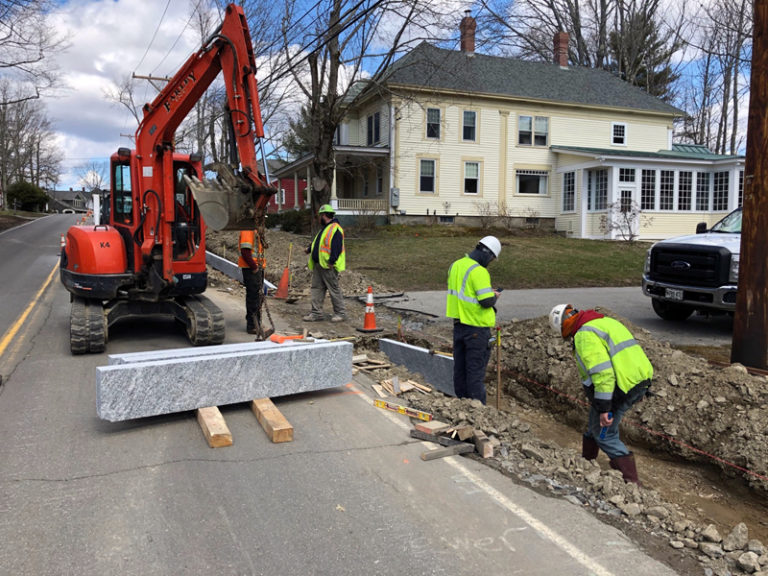 Construction Workers Install Granite Curbing On Bristol Road In 