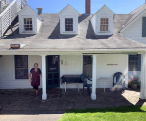 Lucy Martin, co-manager of the Gosnold Arms, comes out of the inn's back door, where customers pick up meals from the Gosnold Pantry. (Alyce McFadden photo)