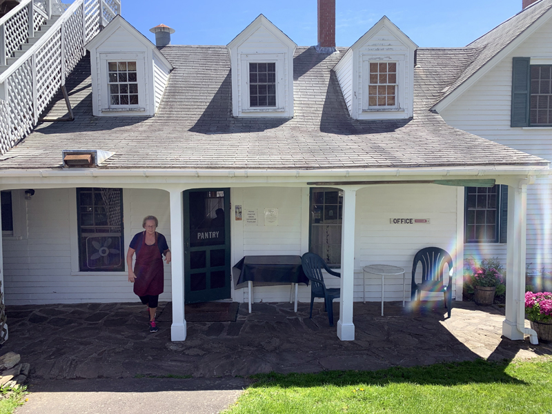 Lucy Martin, co-manager of the Gosnold Arms, comes out of the inn's back door, where customers pick up meals from the Gosnold Pantry. (Alyce McFadden photo)